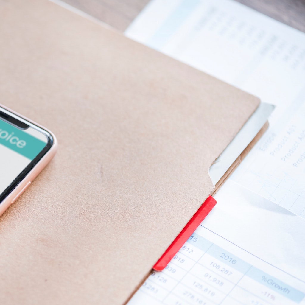 Phone, folder and calendar on a desk